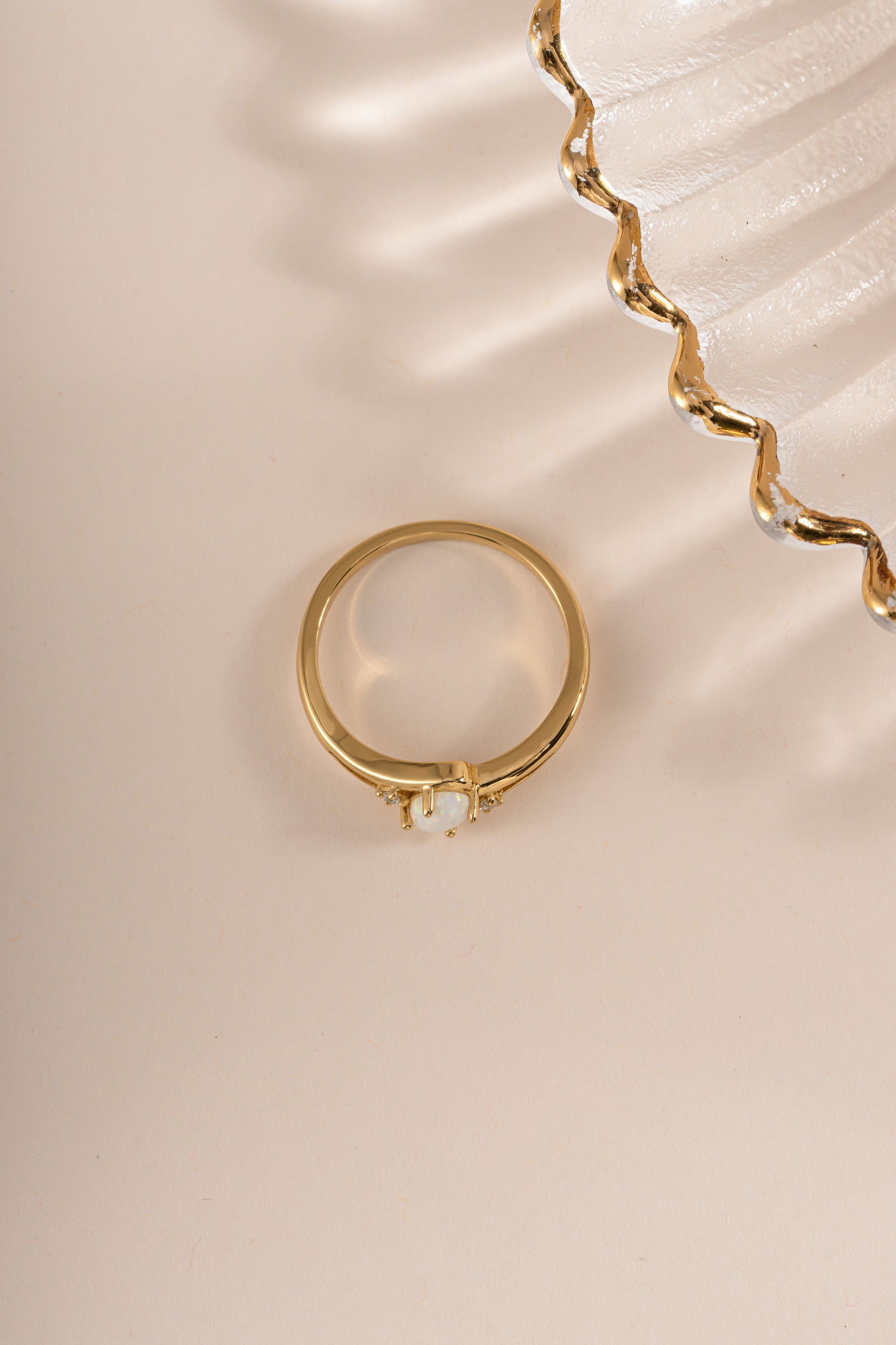Gold small oval opal ring from Sami Jewels, top view showing the smooth oval opal gemstone set in a gold band.
