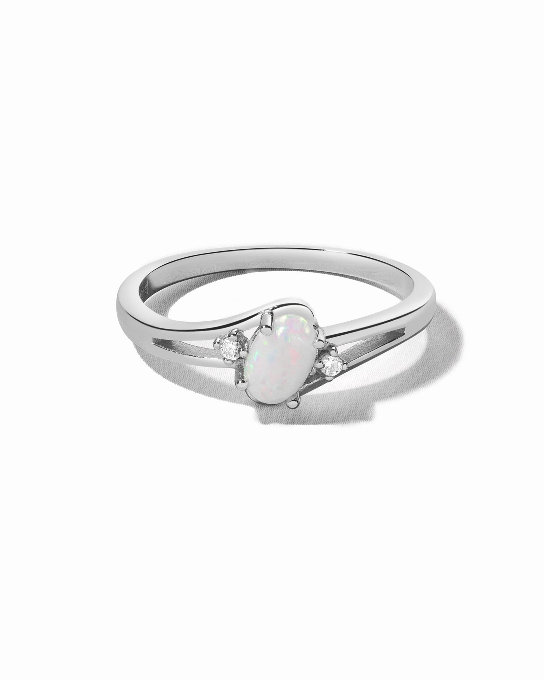Sterling silver small oval opal ring with vibrant white and blue hues, featuring a smooth polished finish.