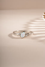 Sterling silver small oval opal ring with vibrant blue and green hues, designed by Sami Jewels.
