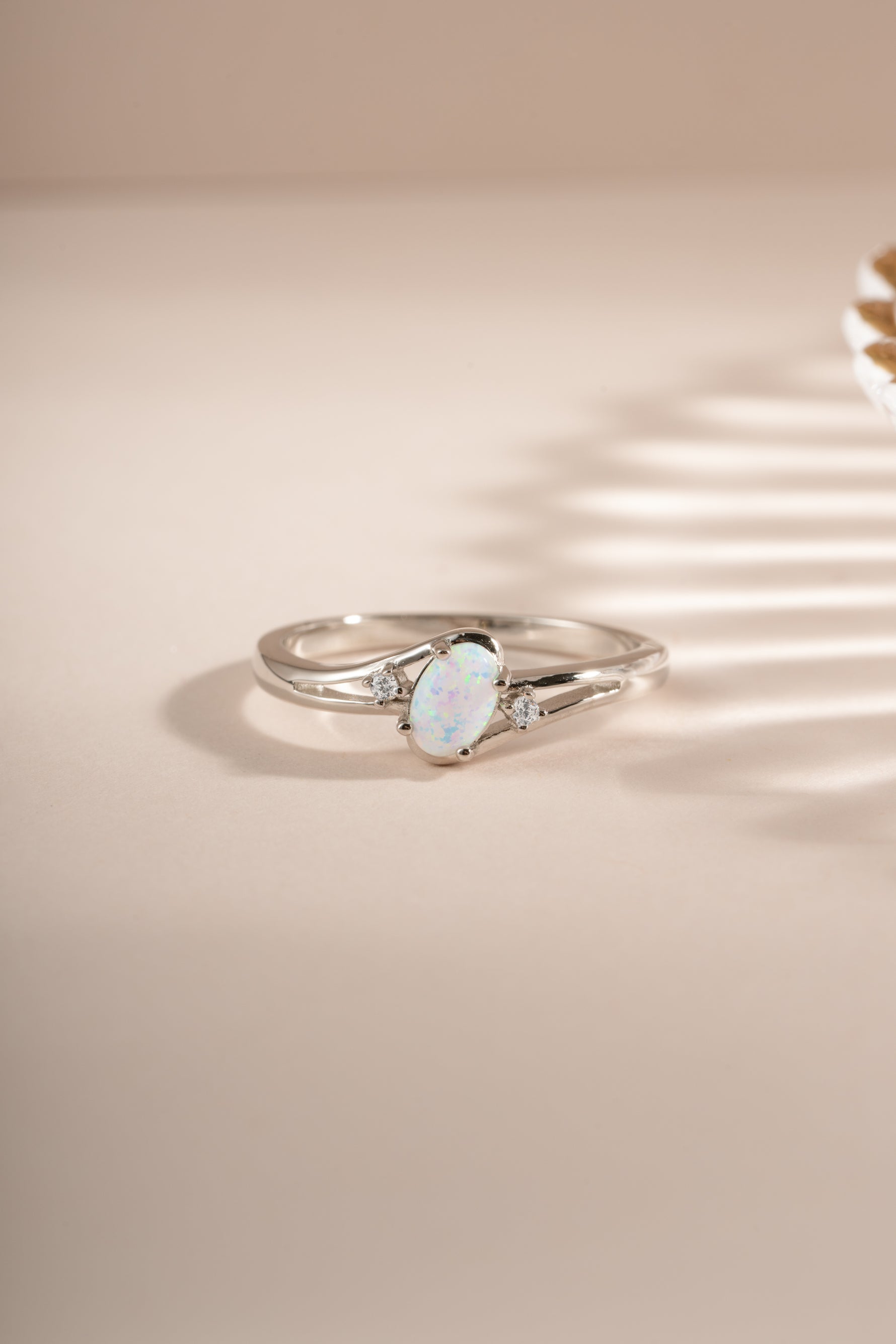 Sterling silver small oval opal ring with vibrant blue and green hues, designed by Sami Jewels.