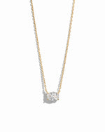 Gold oval pendant necklace by Sami Jewels displayed on a white background, showcasing a sleek and elegant jewelry design.