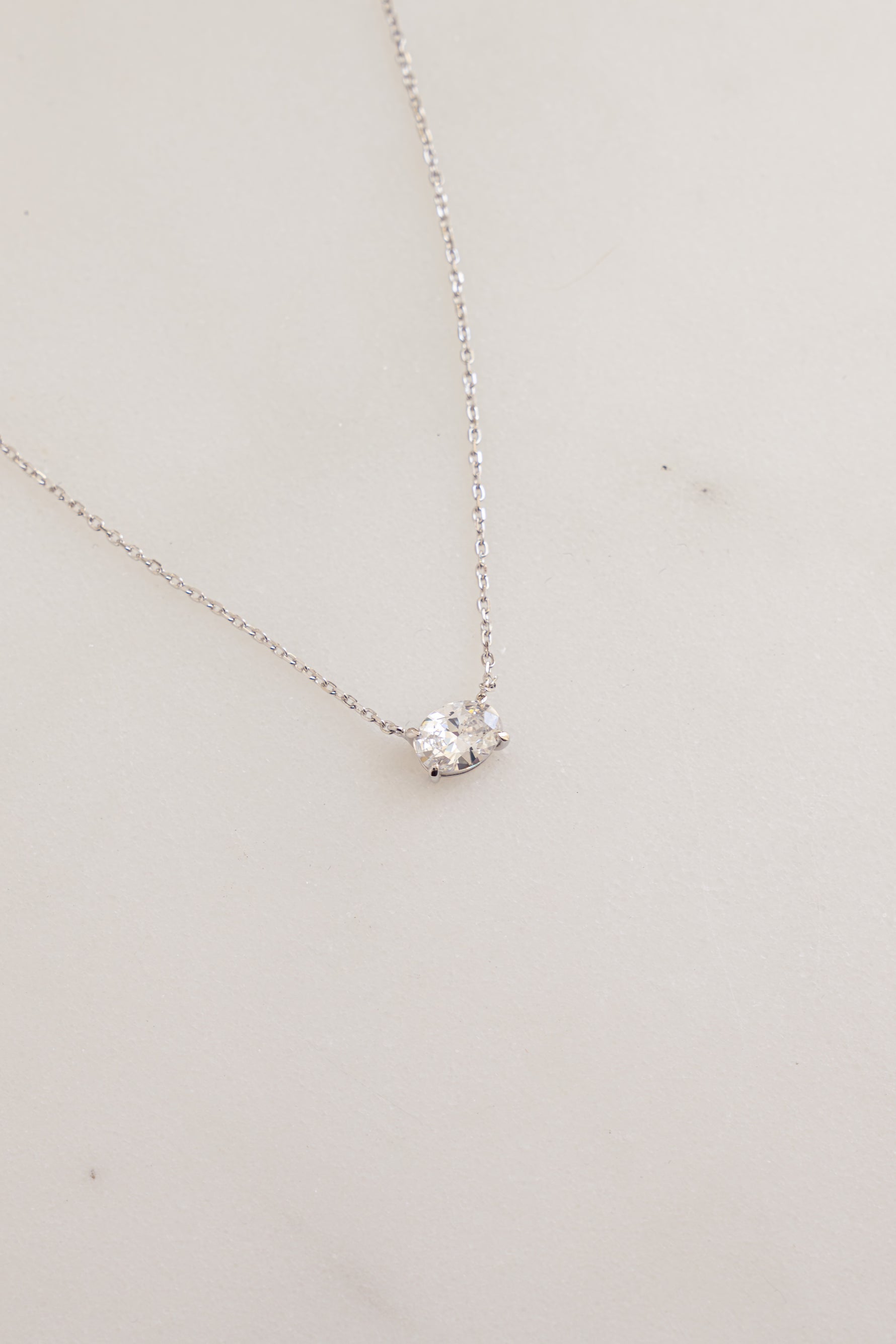 Sterling silver oval pendant necklace from Sami Jewels featuring a close-up view of the elegant jewelry piece.