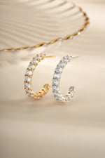 Gold and sterling silver oval studded hoop earrings by Sami Jewels featuring intricate stone details and classic hoop design.