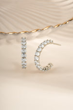 Sterling silver oval studded hoop earrings by Sami Jewels, featuring embedded stones and a sleek hoop design.
