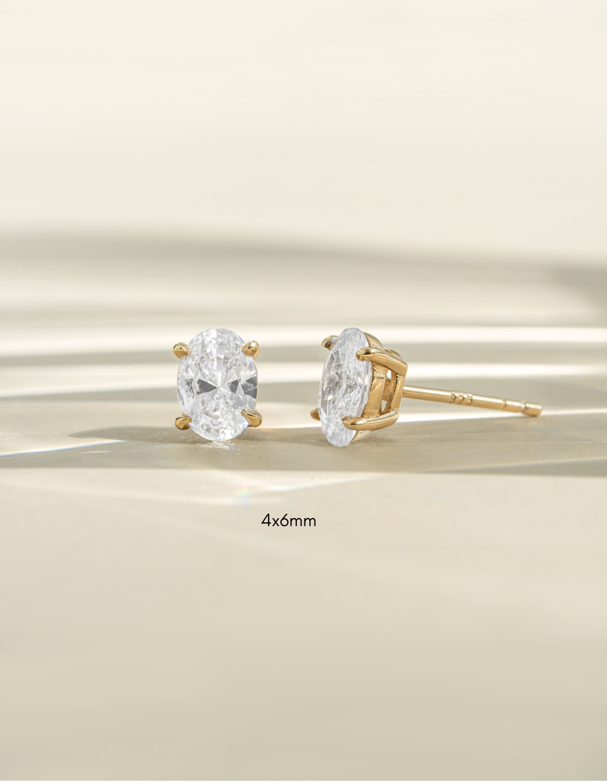 Gold 4x6mm oval stud earrings from Sami Jewels, front view showing smooth, polished surface and classic oval shape.