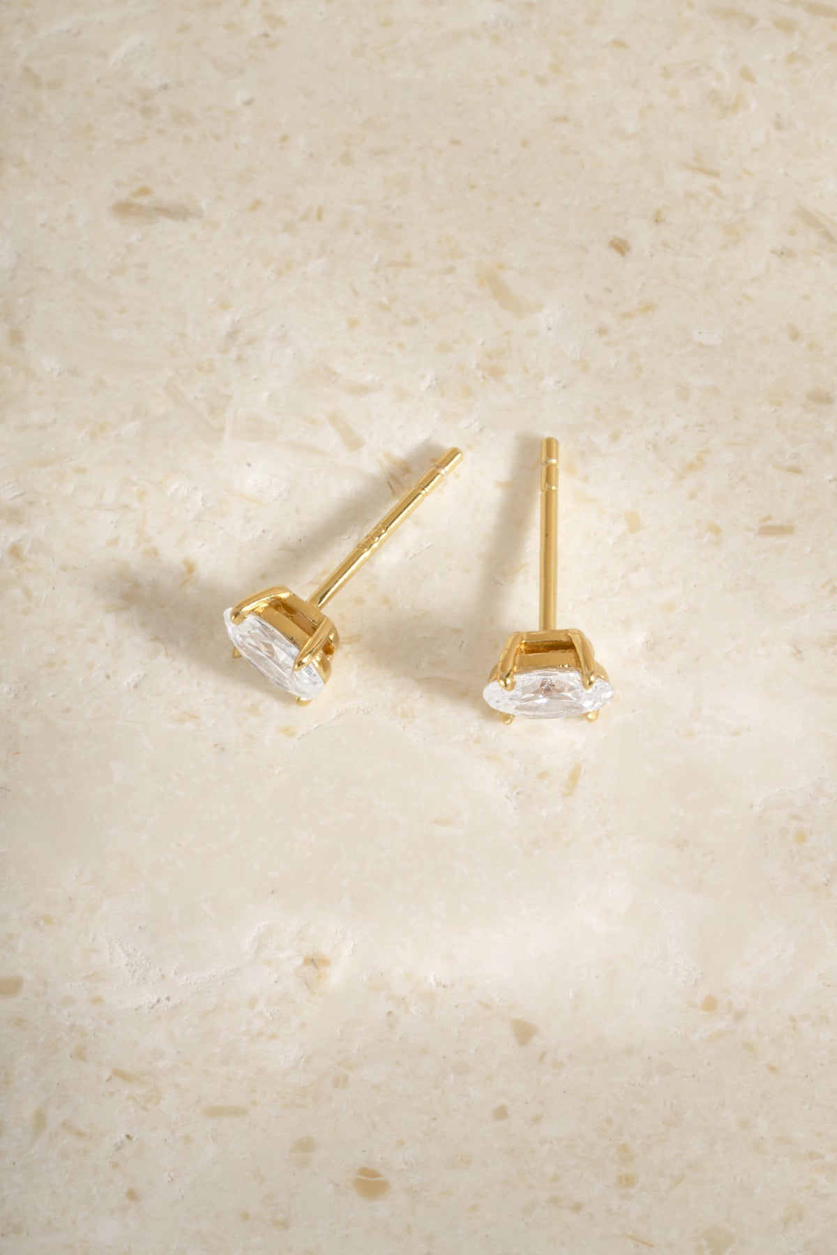Back view of two gold 4x6mm oval studs showing their posts.