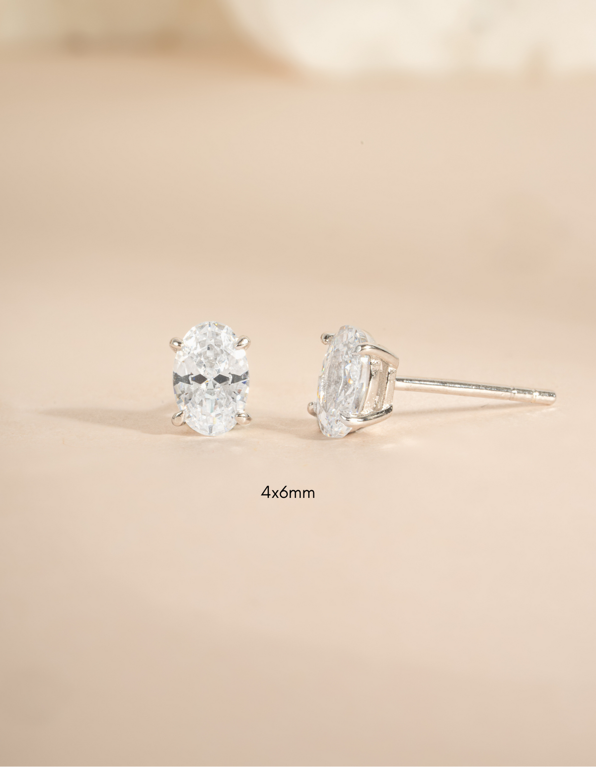 Sterling silver 4x6mm oval stud earrings by Sami Jewels, front view showing smooth polished surface and elegant design.