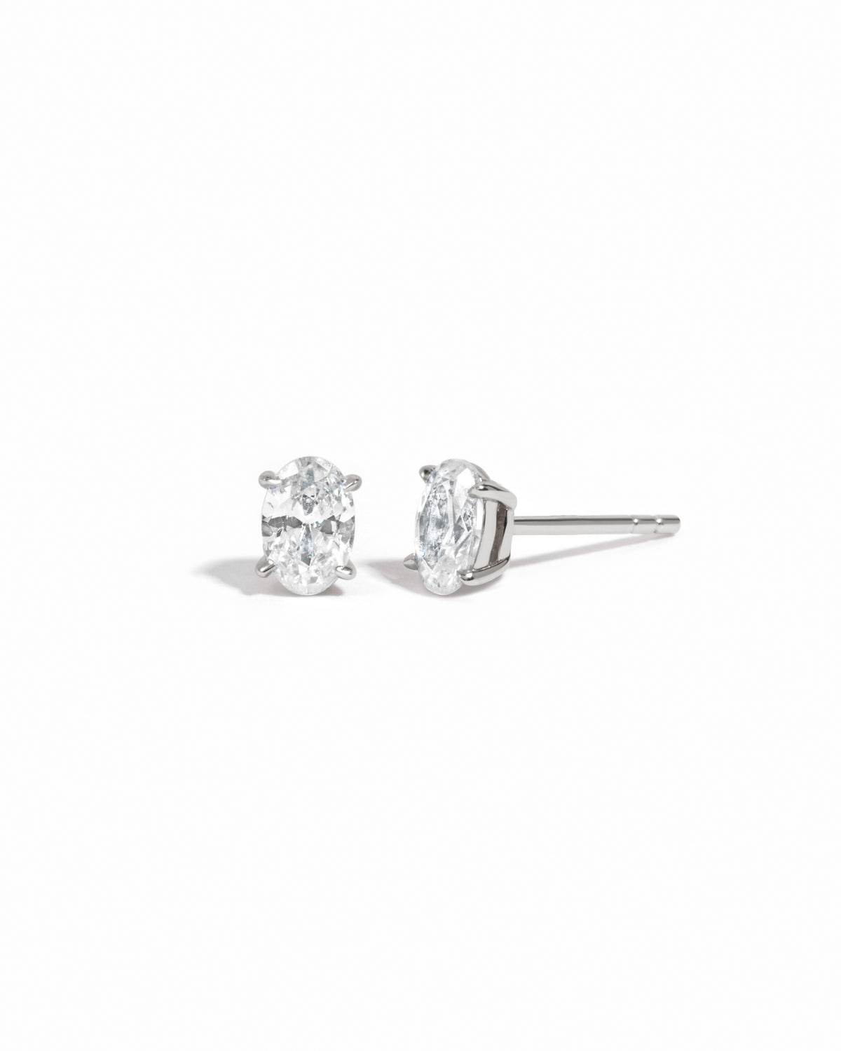 Sterling silver 4x6mm oval stud earrings by Sami Jewels displayed on a white background.