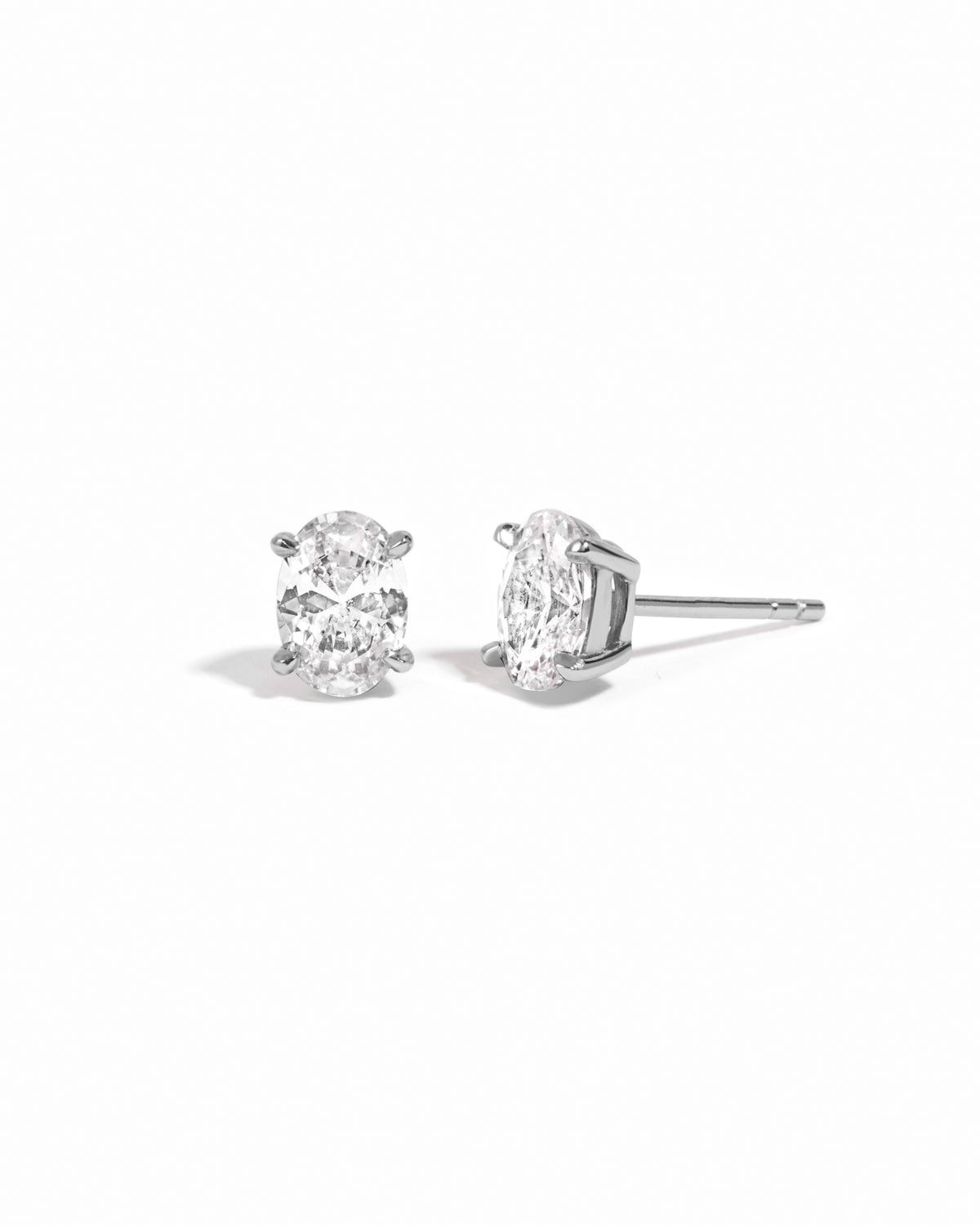 Sterling silver 5x7mm oval stud earrings by Sami Jewels on a white background.