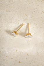 Back view of two gold 6x8mm oval studs showing their posts.