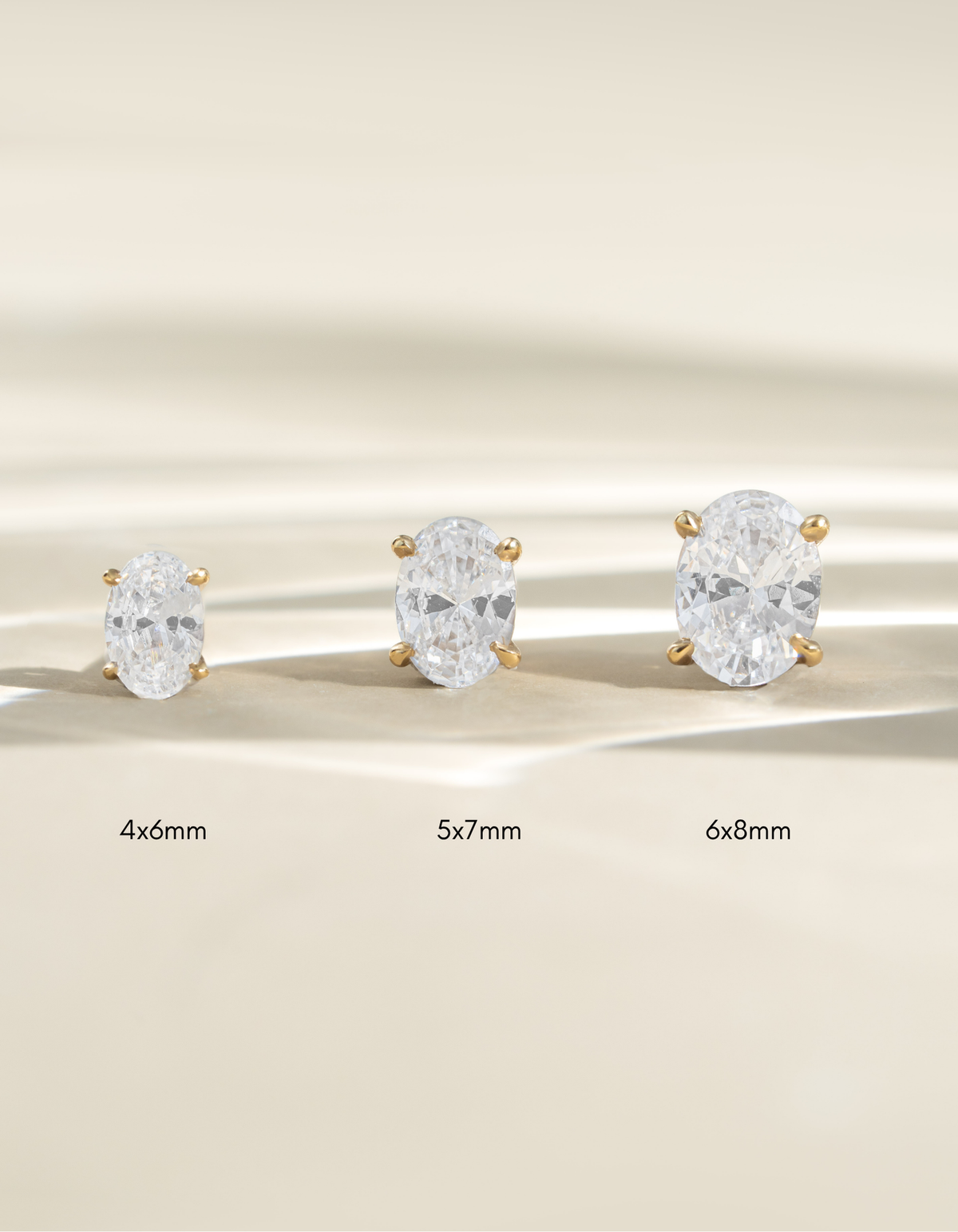 Gold oval stud earrings in three sizes: 4x6mm, 5x7mm, and 6x8mm by Sami Jewels.