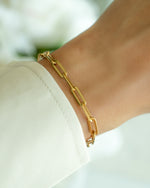 Gold Amanda Paperclip Bracelet by Sami Jewels worn on a model, featuring sleek, interconnected paperclip links for a modern jewelry look.