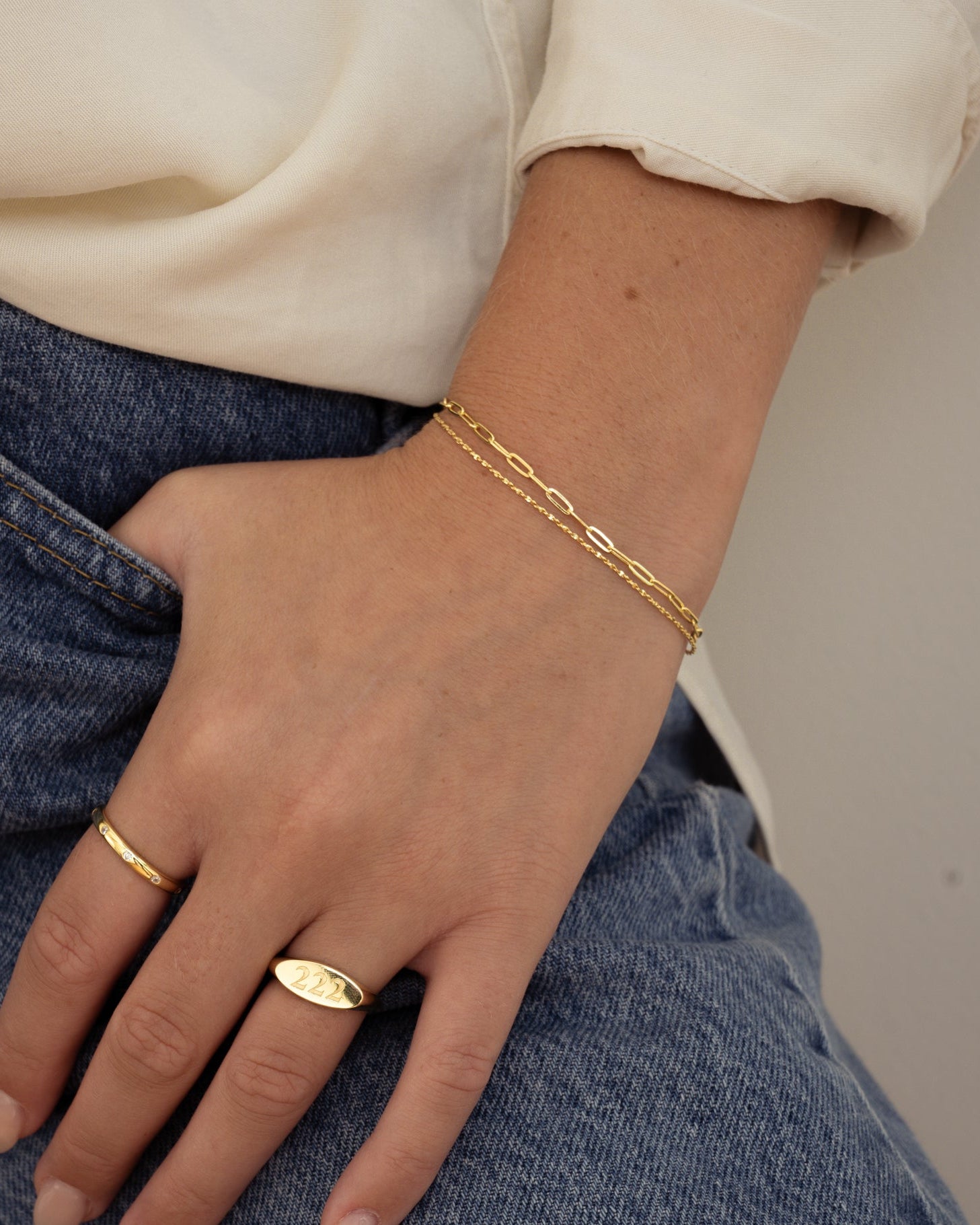 Gold paperclip and chain bracelet set by Sami Jewels, featuring sleek, modern jewelry design worn on a model's wrist.