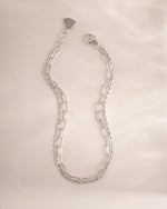 Close-up of Sami Jewels paperclip and chain bracelet set in sterling silver, showcasing sleek, modern jewelry designs.