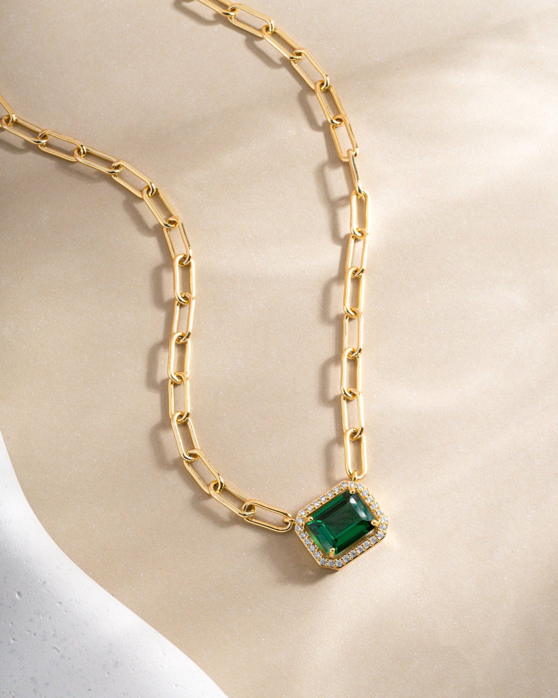 Gold Paperclip Emerald Pendant Necklace by Sami Jewels featuring a sleek chain with a vibrant emerald pendant.