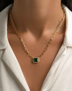 Gold Paperclip Necklace with Emerald Pendant by Sami Jewels, featuring a sleek chain and vibrant green gemstone charm.