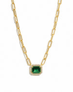 Gold paperclip necklace with emerald pendant from Sami Jewels, featuring a sleek design against a white background.