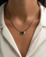 Silver paperclip necklace with emerald pendant from Sami Jewels, showcasing a sleek and modern jewelry design.