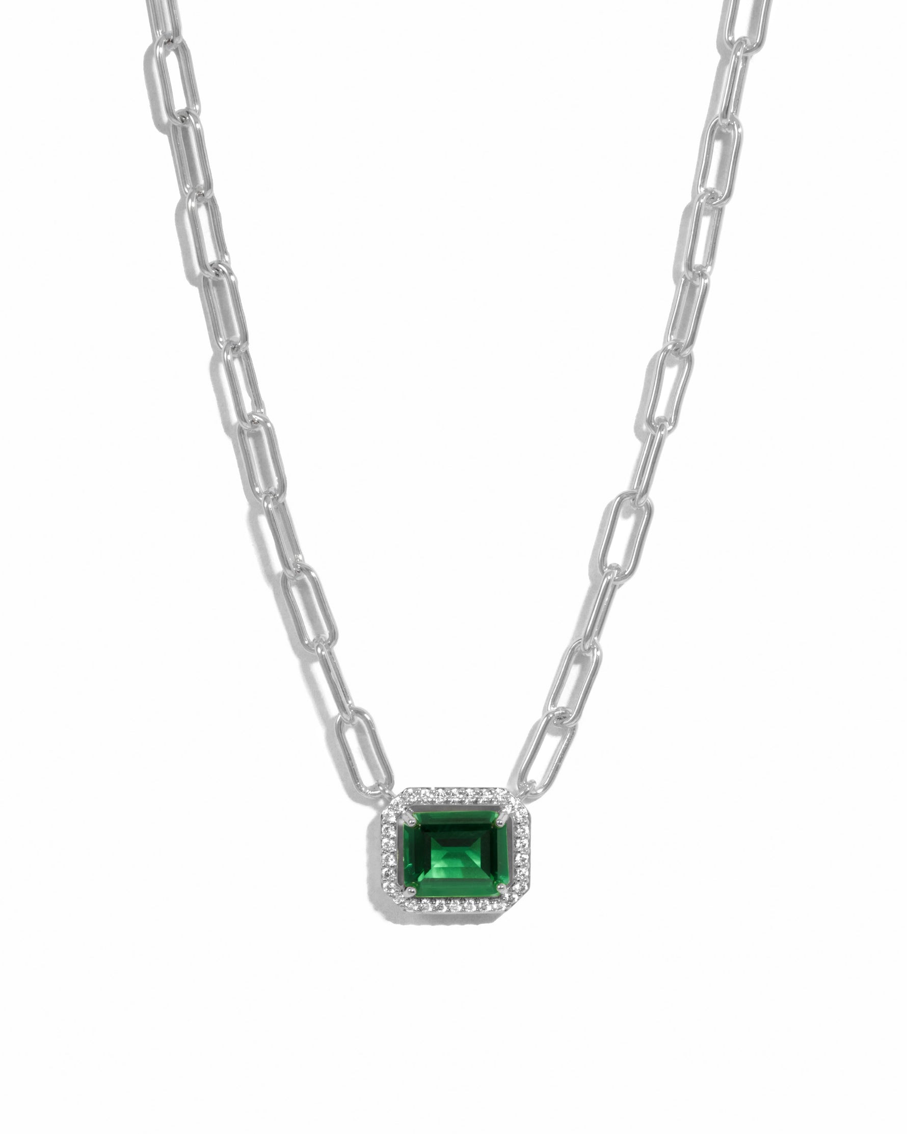 Silver paperclip necklace with emerald pendant from Sami Jewels displayed on a white background.