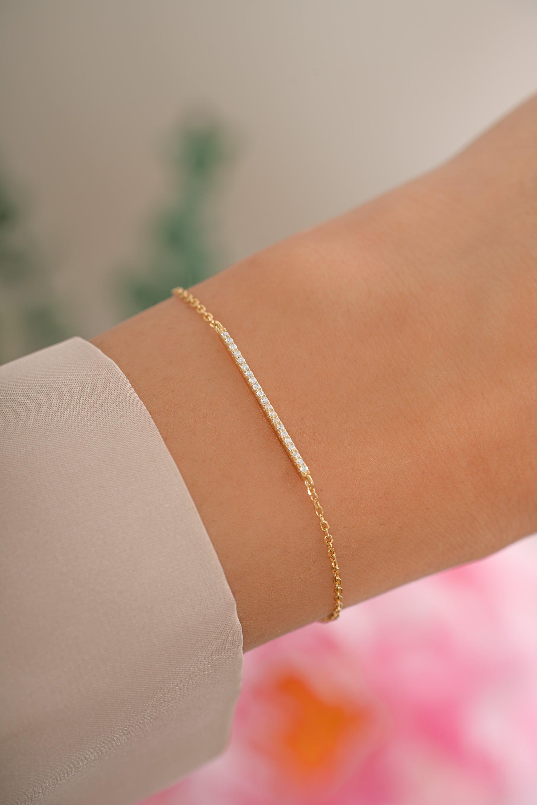 Gold pavé bar bracelet by Sami Jewels featuring a sleek, modern design with sparkling pave accents on a model's wrist.