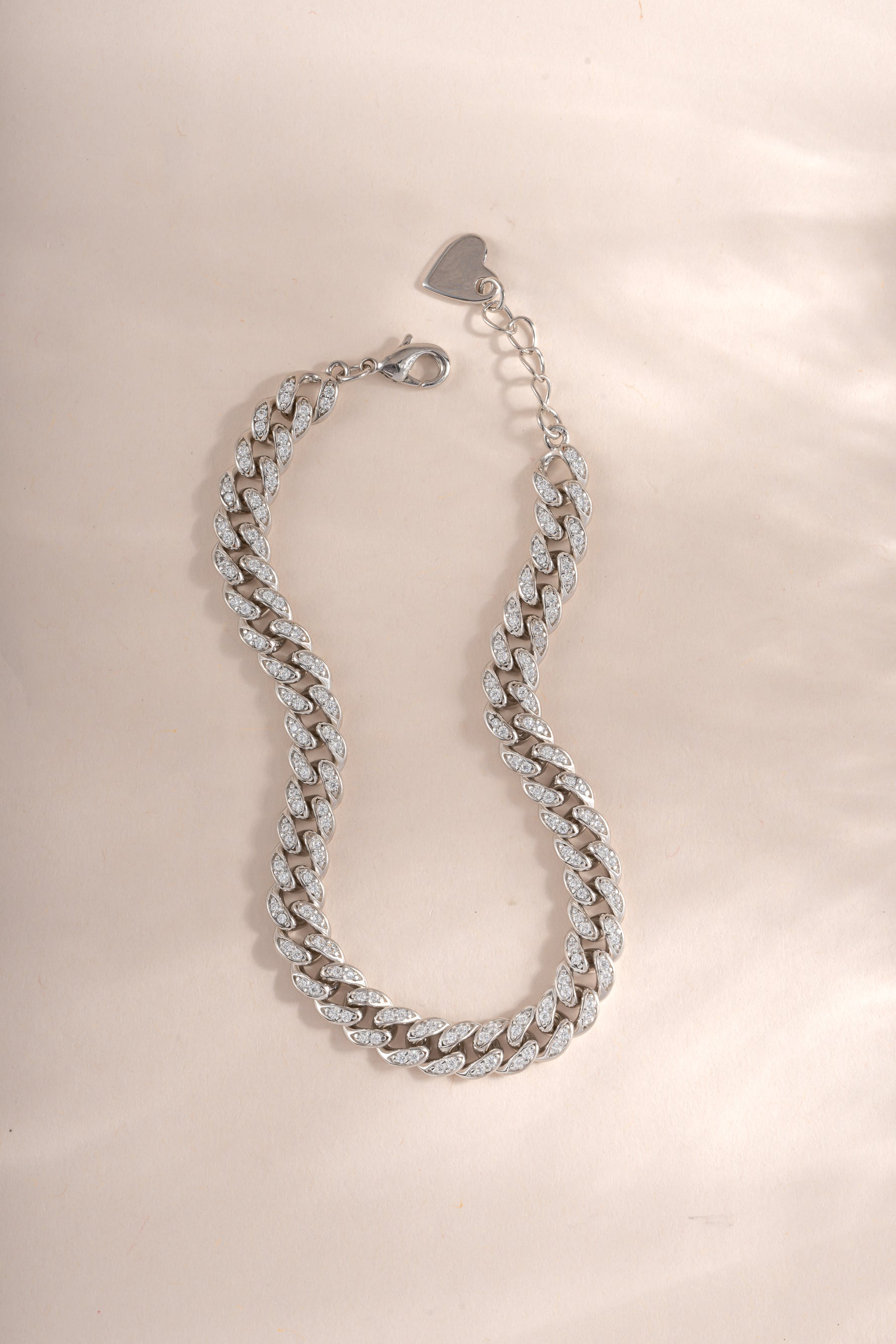 Silver Pavé Chain Link Bracelet by Sami Jewels laid flat, showcasing its intricate pave design and chain link details.