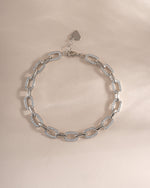 Silver pave chain link bracelet from Sami Jewels, showing a close-up of the intricate chain design on a flat surface.