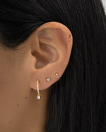 Gold Pavé Charm Huggie Earrings by Sami Jewels, showcasing sparkling stone-encrusted hoops on a model.