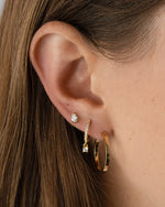 Gold Pavé Charm Huggies earrings by Sami Jewels featuring sparkling pave details on a styled model.
