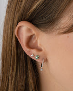 Sterling silver Pavé Charm Huggies earrings worn by a model, featuring sparkling pave details and a stylish, modern design.