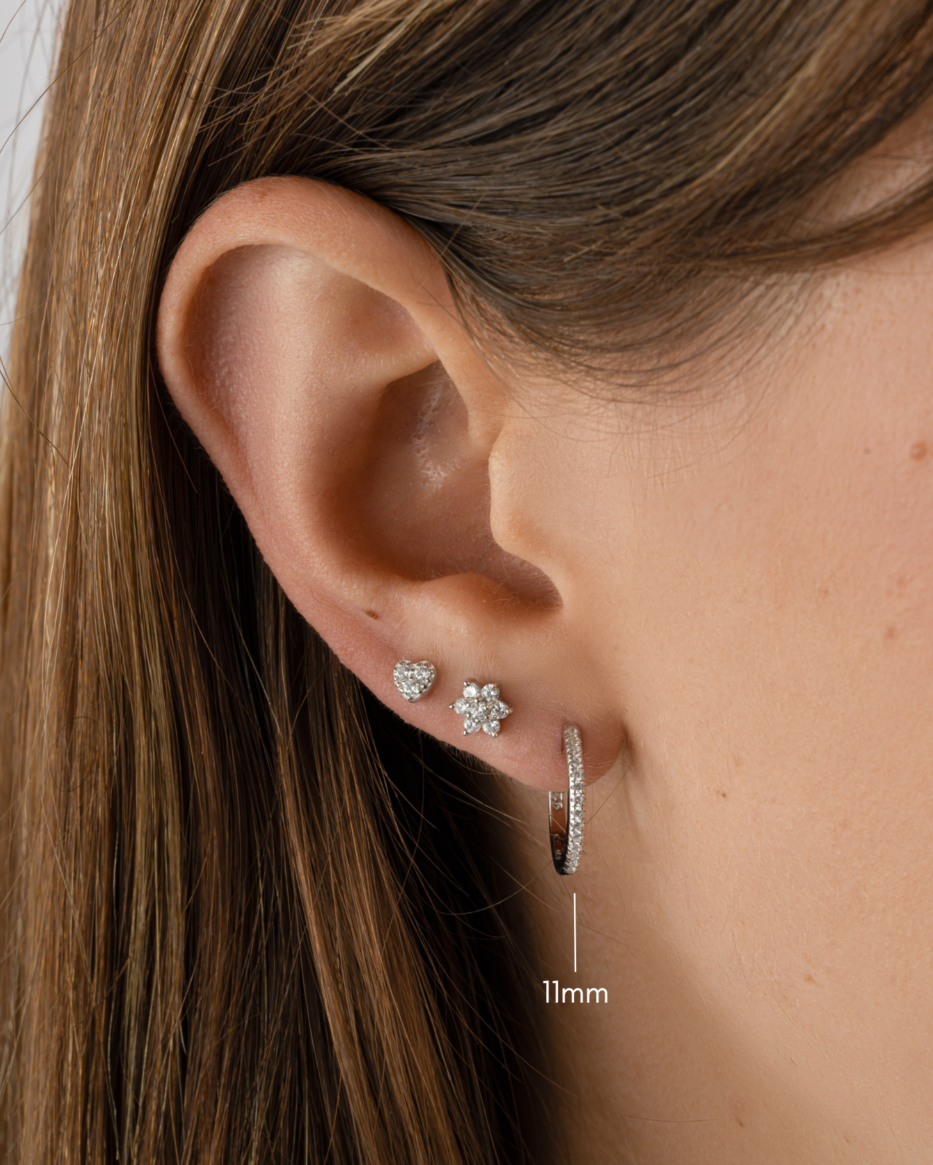 Sterling silver 11mm pavé diamond huggie earrings by Sami Jewels featuring sparkling pave setting on small hoop earrings