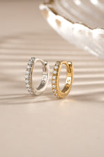 Gold and sterling silver 6mm CZ huggie earrings with pave diamond design by Sami Jewels.