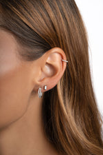 Sterling silver 6mm CZ huggie hoop earrings with pave diamond detailing by Sami Jewels, worn on a model.