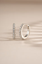 Sterling silver 6mm CZ huggie earrings with pave diamond accents from Sami Jewels, showcasing their elegant, close-fitting hoop design.