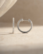 Sterling silver 11mm pavé diamond huggie earrings by Sami Jewels, side view showing sparkling pave design and small hoop size