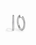 Sterling silver 11mm pavé diamond huggie earrings by Sami Jewels, featuring sparkling pave design on a white background.