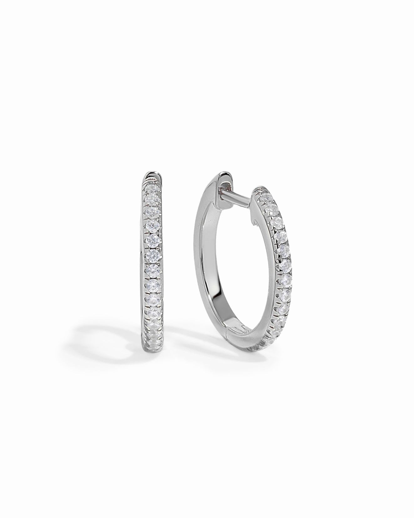 Sterling silver 11mm pavé diamond huggie earrings by Sami Jewels, featuring sparkling pave design on a white background.