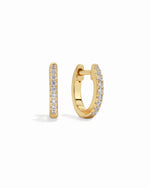 Gold 8mm Pavé Huggie Earrings by Sami Jewels featuring sparkling diamond accents on a white background.