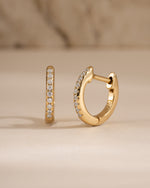 Gold 8mm pavé diamond huggie earrings by Sami Jewels, showcasing sparkling pave setting and classic hoop design.