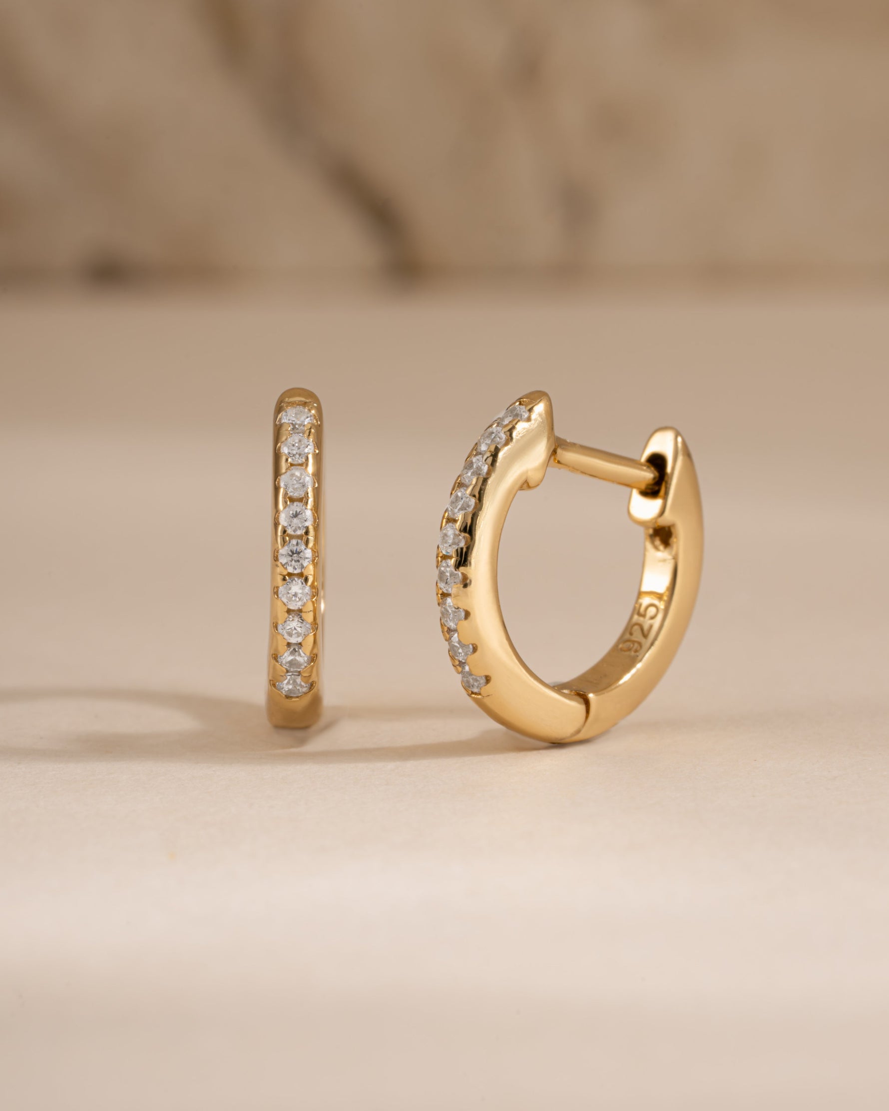 Gold 8mm pavé diamond huggie earrings by Sami Jewels, showcasing sparkling pave setting and classic hoop design.