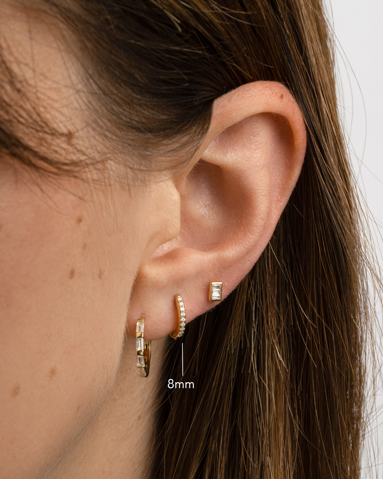 Gold 8mm pavé diamond huggie earrings by Sami Jewels featuring sparkling pave setting and a secure hoop design.