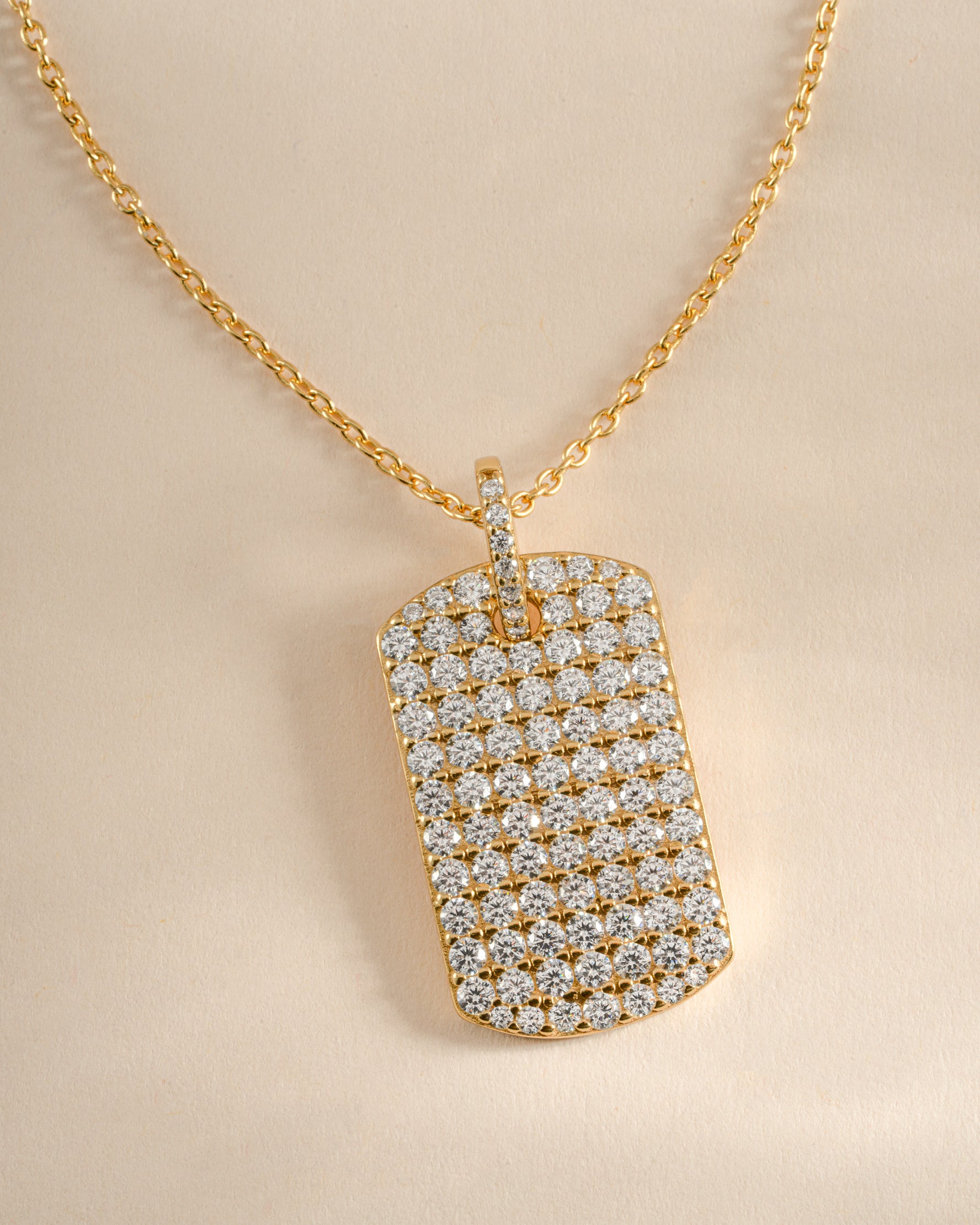 Close-up of Sami Jewels gold Pavé Dog Tag Necklace showcasing sparkling pave details and sleek chain.