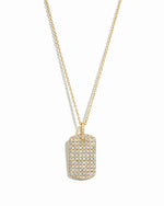Gold pavé dog tag necklace from Sami Jewels displayed on a white background with detailed pave design.
