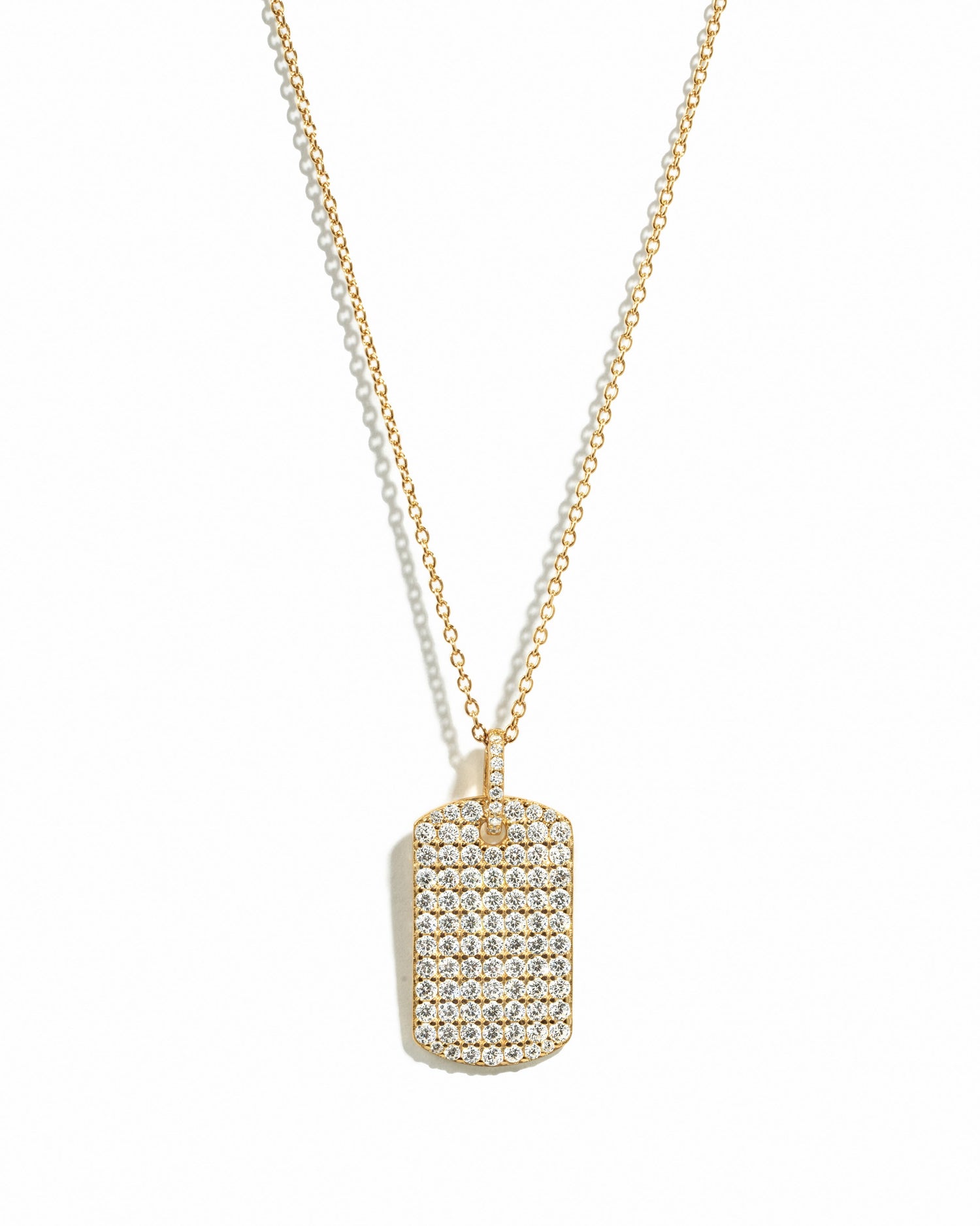 Gold pavé dog tag necklace from Sami Jewels displayed on a white background with detailed pave design.