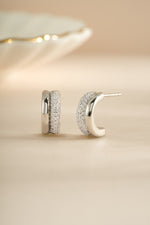 Sterling silver pavé double hoop earrings by Sami Jewels featuring sparkling gemstone accents and a stylish, modern design.
