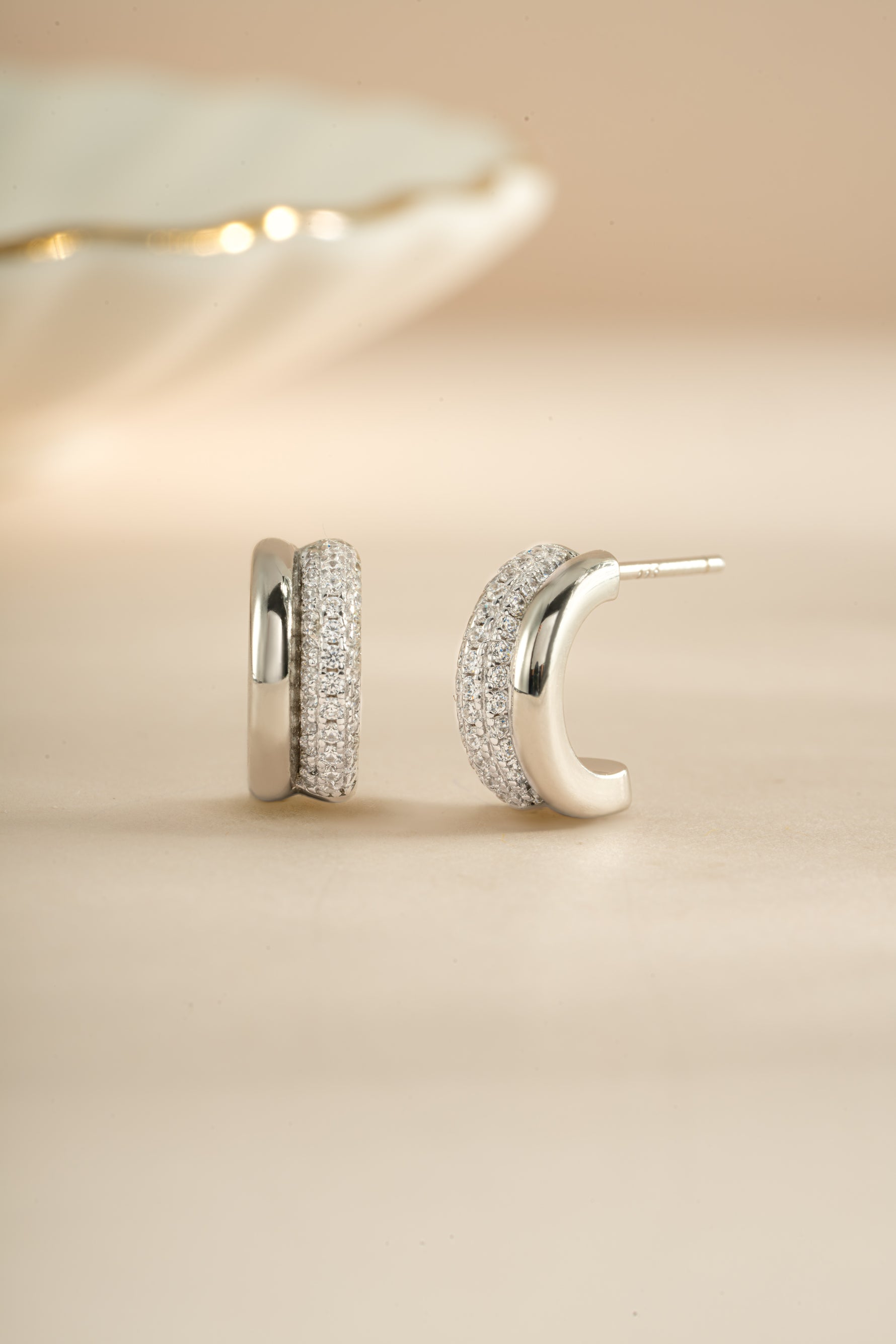 Sterling silver pavé double hoop earrings by Sami Jewels featuring sparkling gemstone accents and a stylish, modern design.