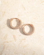 Rose gold 14mm pavé hoop earrings by Sami Jewels, showcasing sparkling small gemstones in a stylish hoop design.