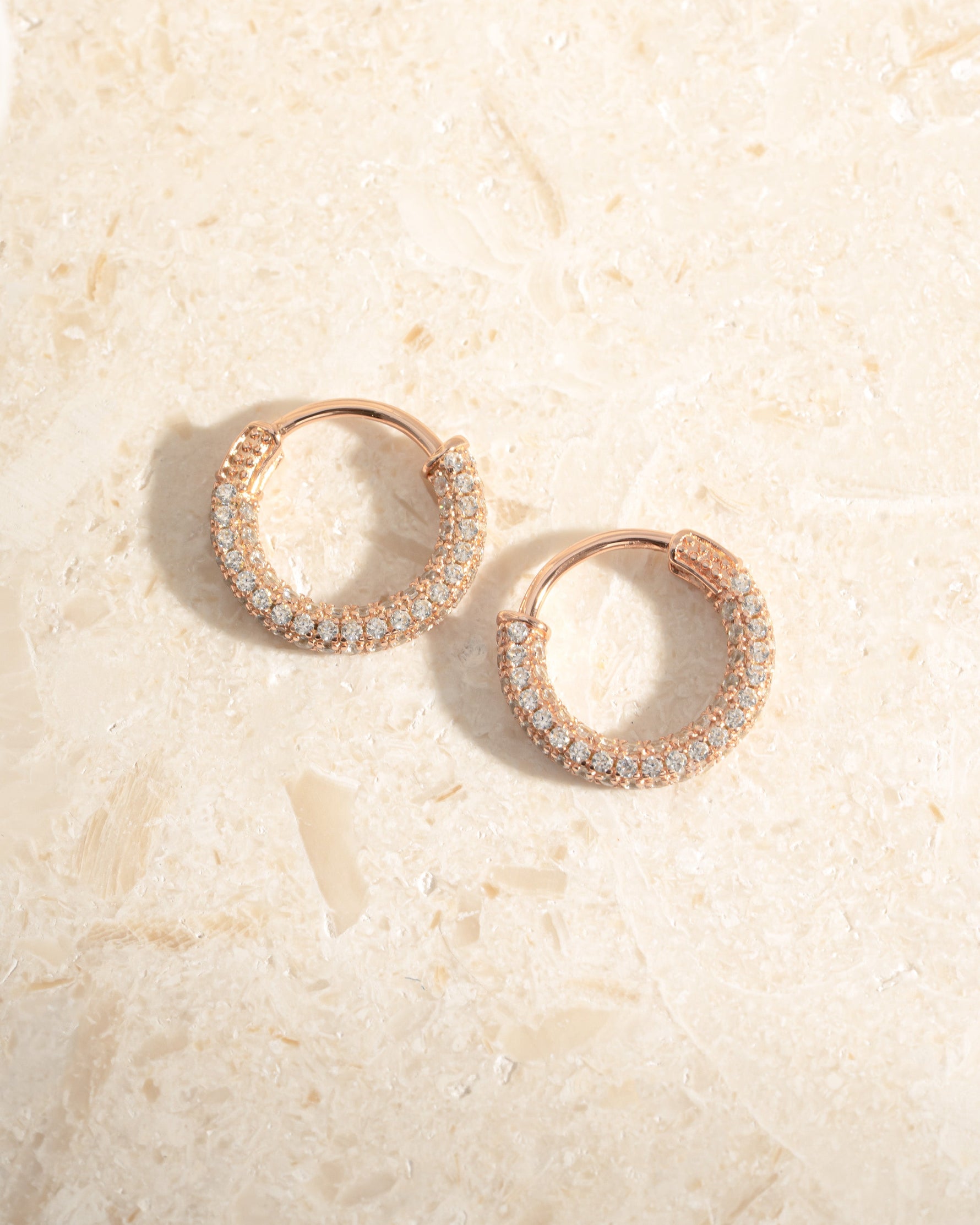 Rose gold 14mm pavé hoop earrings by Sami Jewels, showcasing sparkling small gemstones in a stylish hoop design.