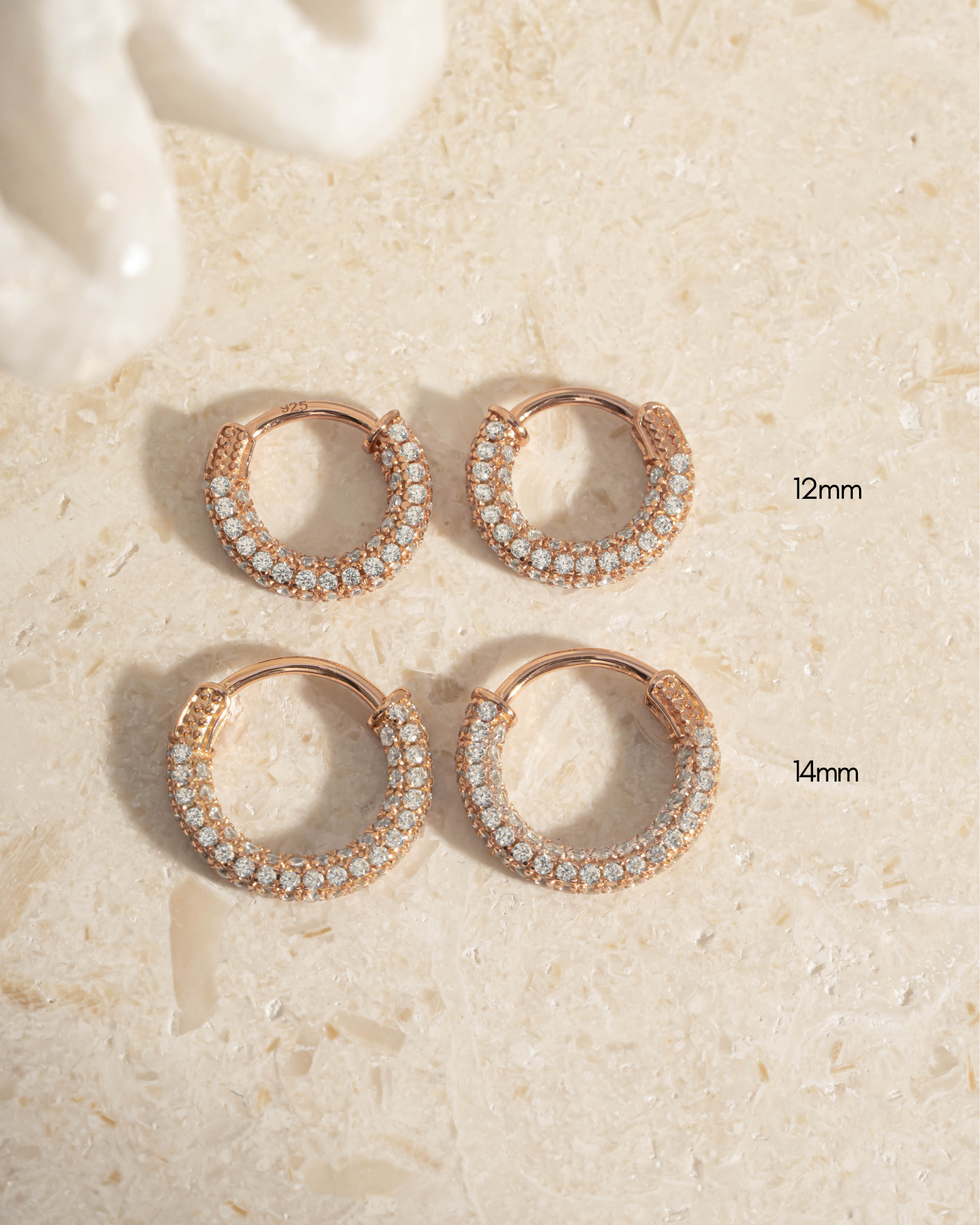 Rose gold 12mm pavé hoop earrings by Sami Jewels, featuring multiple sizes with sparkling gemstone accents.