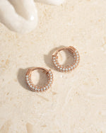 Rose gold 12mm pavé hoop earrings by Sami Jewels, showcasing sparkling pave detailing and a stylish hoop design.