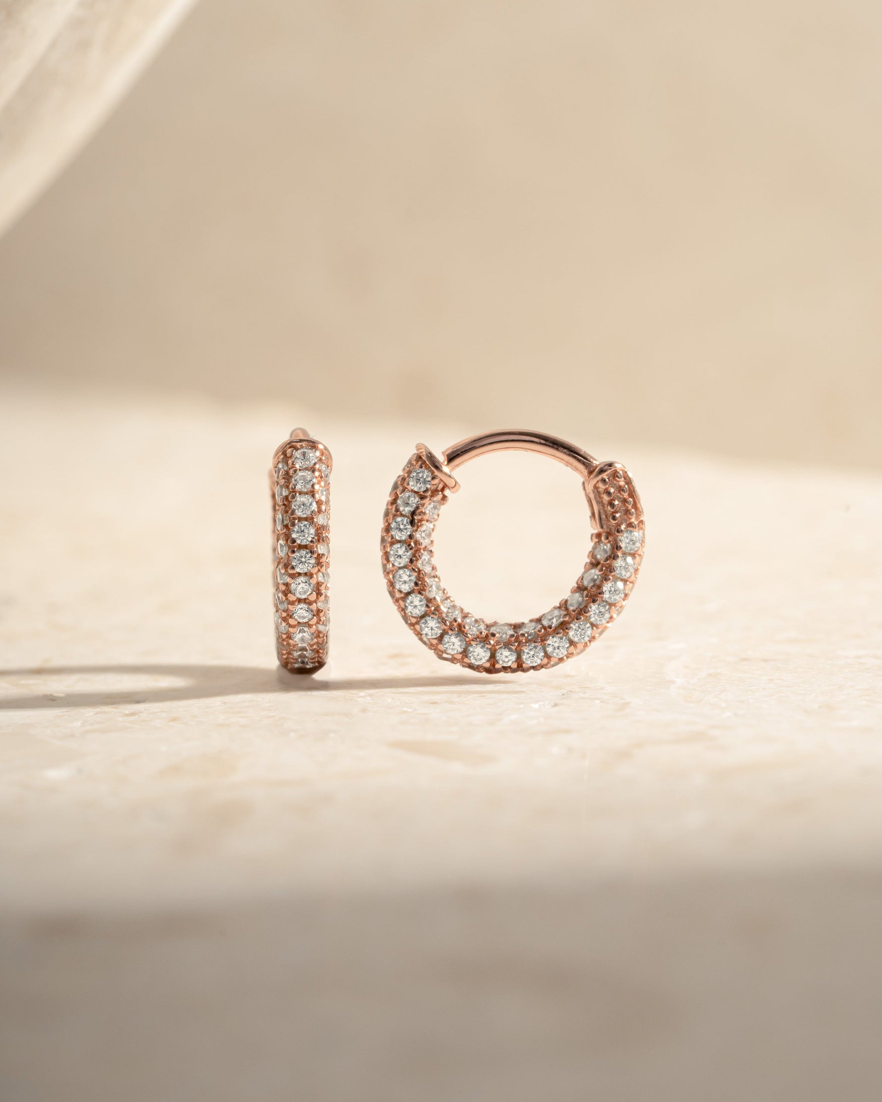Rose gold 12mm pavé hoop earrings by Sami Jewels featuring sparkling embedded stones and classic hoop design